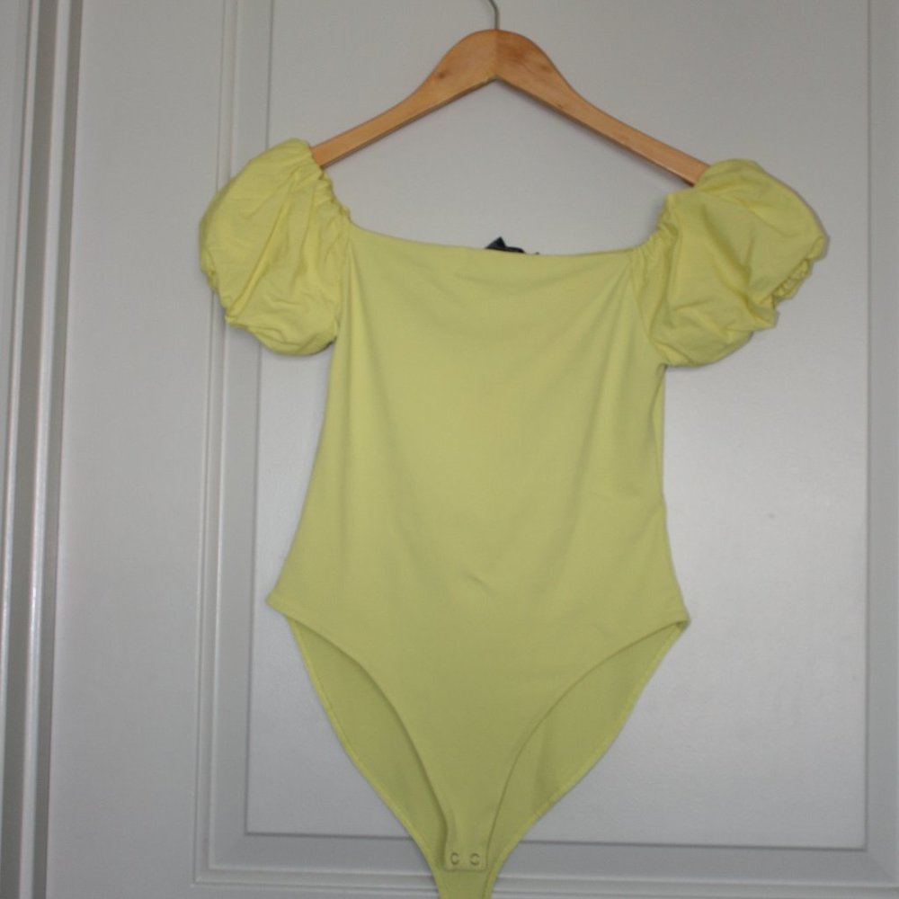 Yellow blouse that is tight on body